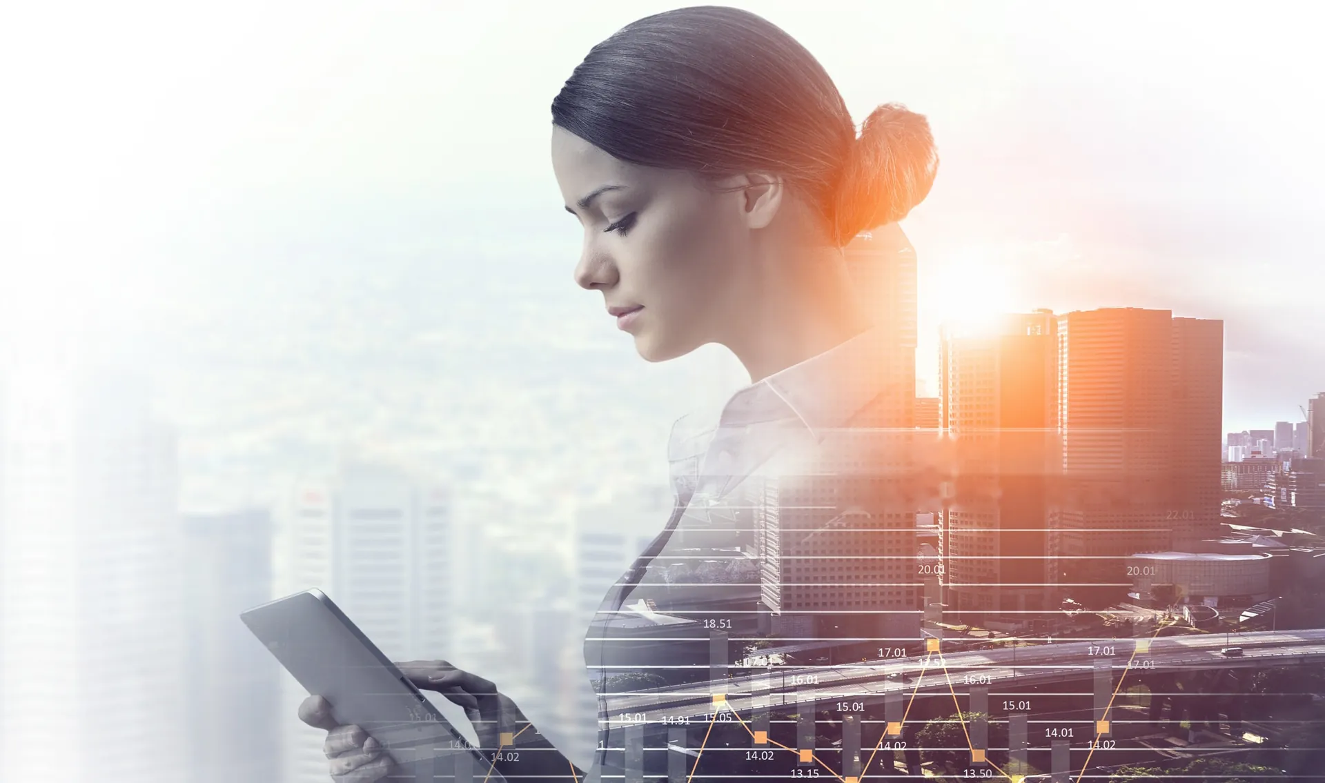 A business owner checks her website on a tablet, city skyline at sunset